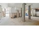 Unfinished basement area featuring concrete pillars, storage cabinets, and door to outside at 232 Haddrell St, Mount Pleasant, SC 29464