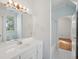 Bathroom featuring a large mirror, vanity with sink, and a bathtub with shower at 232 Haddrell St, Mount Pleasant, SC 29464