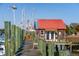 Charming shed with a red roof at the end of a weathered wooden dock with boat access at 232 Haddrell St, Mount Pleasant, SC 29464