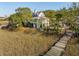 Beautiful coastal home with lush marsh views accessible by a private wooden dock at 232 Haddrell St, Mount Pleasant, SC 29464