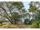 Charming two-story home framed by mature trees in the front yard at 232 Haddrell St, Mount Pleasant, SC 29464
