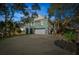 Exterior of a coastal home with a garage, driveway, and mature trees at 232 Haddrell St, Mount Pleasant, SC 29464