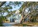 Two-story home with a garage surrounded by lush greenery and trees at 232 Haddrell St, Mount Pleasant, SC 29464