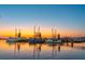 Scenic view of several docked fishing boats at sunset, reflecting on the water at 232 Haddrell St, Mount Pleasant, SC 29464