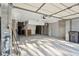 Spacious two-car garage with concrete walls, door to side yard, and access to main house at 232 Haddrell St, Mount Pleasant, SC 29464