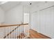 Upstairs hallway features hardwood floors, white walls, and closet space at 232 Haddrell St, Mount Pleasant, SC 29464