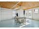 Cozy room featuring painted floor and wood ceiling, complete with dining area and natural light at 232 Haddrell St, Mount Pleasant, SC 29464