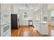 Bright eat-in kitchen with stainless steel appliances, white cabinets, and hardwood floors at 232 Haddrell St, Mount Pleasant, SC 29464