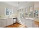 Sunny kitchen features stainless steel appliances, white cabinets, and hardwood floors at 232 Haddrell St, Mount Pleasant, SC 29464
