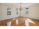 Open living room with hardwood floors, large windows, and chandelier lighting at 232 Haddrell St, Mount Pleasant, SC 29464