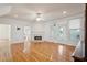 Spacious living room featuring hardwood floors, a fireplace, and large windows at 232 Haddrell St, Mount Pleasant, SC 29464