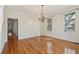 An empty living room featuring views from the exterior and chandelier lighting at 232 Haddrell St, Mount Pleasant, SC 29464