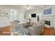 Virtually staged living room with hardwood floors, a fireplace, and comfortable seating at 232 Haddrell St, Mount Pleasant, SC 29464