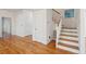 Bright foyer with wood floors, white stairs, and a decorative stained glass window at 232 Haddrell St, Mount Pleasant, SC 29464