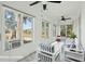Staged sunroom with tile floor, many windows, ceiling fans, and cozy furniture at 232 Haddrell St, Mount Pleasant, SC 29464