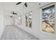 Large sunroom with tile floor, numerous windows, and ceiling fans offers natural light at 232 Haddrell St, Mount Pleasant, SC 29464