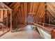 Unfinished attic space with wooden beams and natural light, offering potential for customization at 24 N Basilica Ave, Hanahan, SC 29410