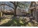 Landscaped backyard featuring a charming brick storage building, patio furniture, and a spacious lawn at 24 N Basilica Ave, Hanahan, SC 29410