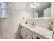 Bathroom boasts white marble walls, a modern vanity, and a large framed mirror for a luxurious feel at 24 N Basilica Ave, Hanahan, SC 29410