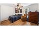 Cozy bedroom with hardwood floors, a ceiling fan, and a bright window allowing natural light at 24 N Basilica Ave, Hanahan, SC 29410