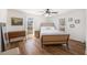 Bedroom featuring hardwood floors, a ceiling fan, and bright windows allowing lots of natural light at 24 N Basilica Ave, Hanahan, SC 29410
