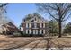 Charming two-story brick home featuring a balcony and mature trees on a neatly kept lawn at 24 N Basilica Ave, Hanahan, SC 29410