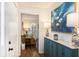 Inviting hallway with hardwood floors, a blue cabinet, and a glimpse into the cozy living room at 24 N Basilica Ave, Hanahan, SC 29410