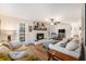 Comfortable living room with hardwood floors, neutral decor, and a striking white brick fireplace at 24 N Basilica Ave, Hanahan, SC 29410