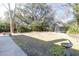 A expansive backyard includes a large grassy area, shed, mature trees, and bird bath at 26 Beverly Rd, Charleston, SC 29407