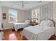 Charming bedroom featuring hardwood floors, two twin beds, and wallpaper accents at 26 Beverly Rd, Charleston, SC 29407