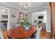 Elegant dining room with hardwood floors, chandelier, and seamless flow to the living room at 26 Beverly Rd, Charleston, SC 29407