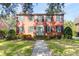 Traditional brick home with a well-manicured lawn and mature trees, offering timeless curb appeal at 26 Beverly Rd, Charleston, SC 29407