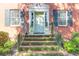 Close-up of the inviting entryway, showcasing the charming pale green front door and detailed brickwork at 26 Beverly Rd, Charleston, SC 29407