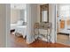 Hallway showcasing hardwood floors, a decorative table with Gathering photos, and views into the bedroom and bathroom at 26 Beverly Rd, Charleston, SC 29407
