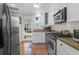 Modern kitchen with stainless steel appliances, granite countertops, and access to a deck at 26 Beverly Rd, Charleston, SC 29407