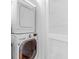 Efficient laundry area featuring a stacked washer and dryer, and a white slatted door at 26 Beverly Rd, Charleston, SC 29407