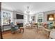 Spacious living room with a fireplace, large windows, and refined design, perfect for relaxation at 26 Beverly Rd, Charleston, SC 29407