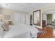 This spacious bedroom boasts hardwood floors, a large mirror, and a ceiling fan at 26 Beverly Rd, Charleston, SC 29407
