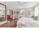 This bright bedroom features a seating area, ceiling fan, large mirror, and hardwood floors at 26 Beverly Rd, Charleston, SC 29407