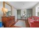 A beautifully decorated sitting room features hardwood floors, a desk, and plenty of natural light at 26 Beverly Rd, Charleston, SC 29407