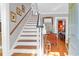 An elegant staircase with wood and white details leads to the upper level at 26 Beverly Rd, Charleston, SC 29407