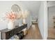 Bright and airy hallway featuring wood floors, stylish decor, and a glimpse into the living area at 269 Firewheel Ct, Summerville, SC 29486