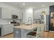Spacious kitchen with stainless steel appliances, granite counters, seating, and light grey cabinetry at 269 Firewheel Ct, Summerville, SC 29486