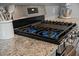 Close up of a stainless steel gas range and granite countertop in a modern kitchen at 269 Firewheel Ct, Summerville, SC 29486
