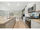 Bright kitchen with stainless appliances, and granite countertops open to dining and living area at 269 Firewheel Ct, Summerville, SC 29486
