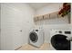 Modern laundry room with side-by-side washer and dryer and added storage shelves at 269 Firewheel Ct, Summerville, SC 29486