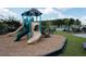 Community playground featuring slides and play equipment with a view of the pool and pergola at 269 Firewheel Ct, Summerville, SC 29486