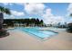 Large community pool with a splash pad and plenty of seating on a sunny day at 269 Firewheel Ct, Summerville, SC 29486