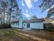 The light blue house exterior has a patio area and sliding glass doors that lead to a large backyard space at 2929 Salamander Creek Ln, North Charleston, SC 29406