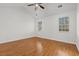 The bedroom features wood floors, a ceiling fan, and windows that provide natural light at 2929 Salamander Creek Ln, North Charleston, SC 29406